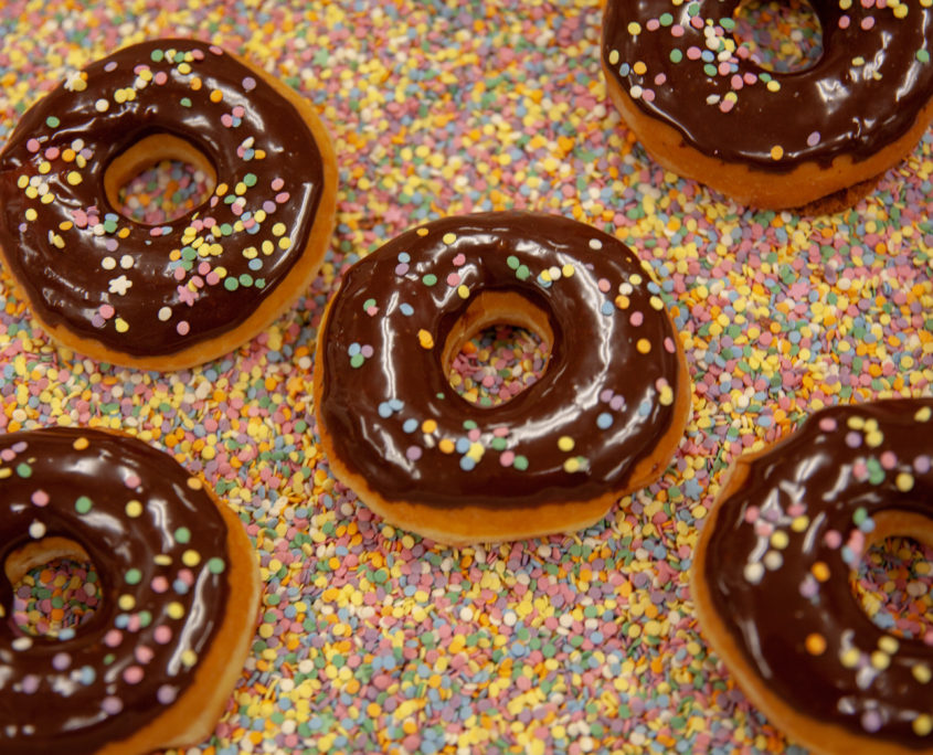 Maritime Coffee Time chocolate topped donuts multicolored sprinkles